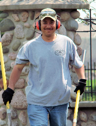 Dino Ioakimidis outside pushing wheelbarrow