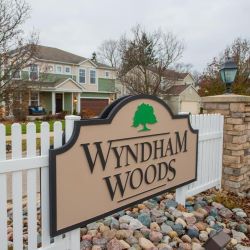 Wyndham Woods sign in front of a house in Wyndham Woods Crown Point